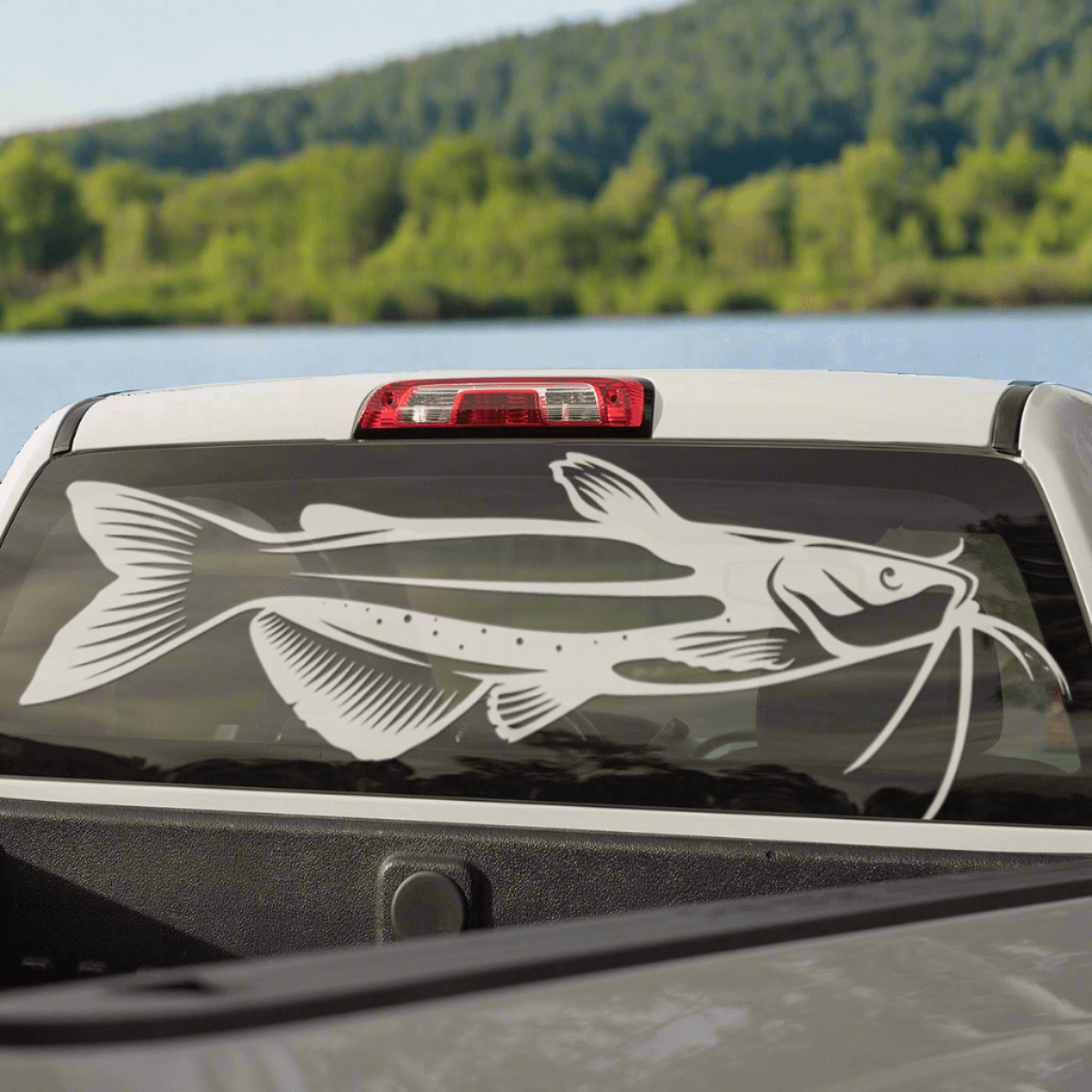 Large white colored Channel Catfish Decal on the rear window of a pickup truck.