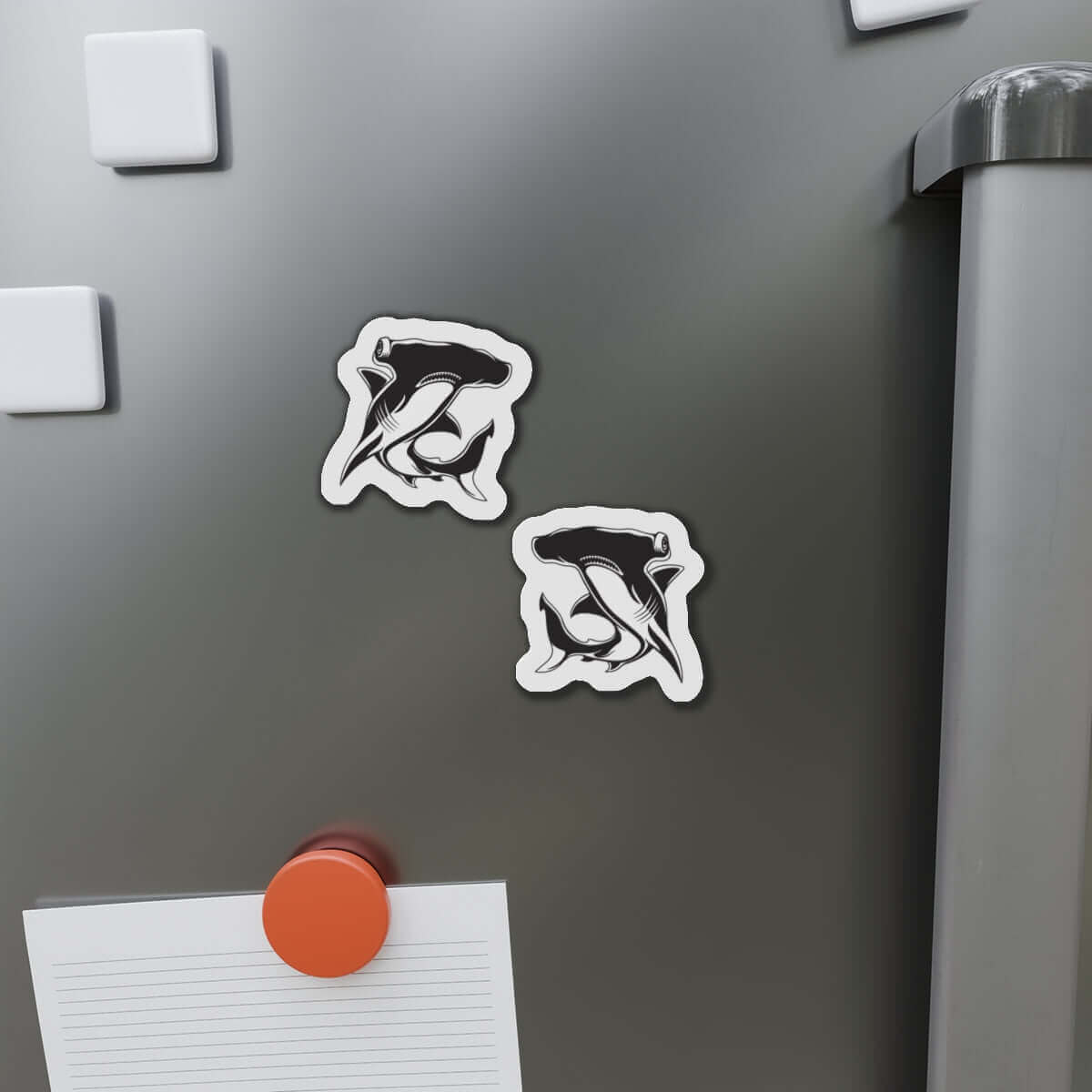 Hammerhead Shark fish-shaped magnets on fridge for fun kitchen décor.