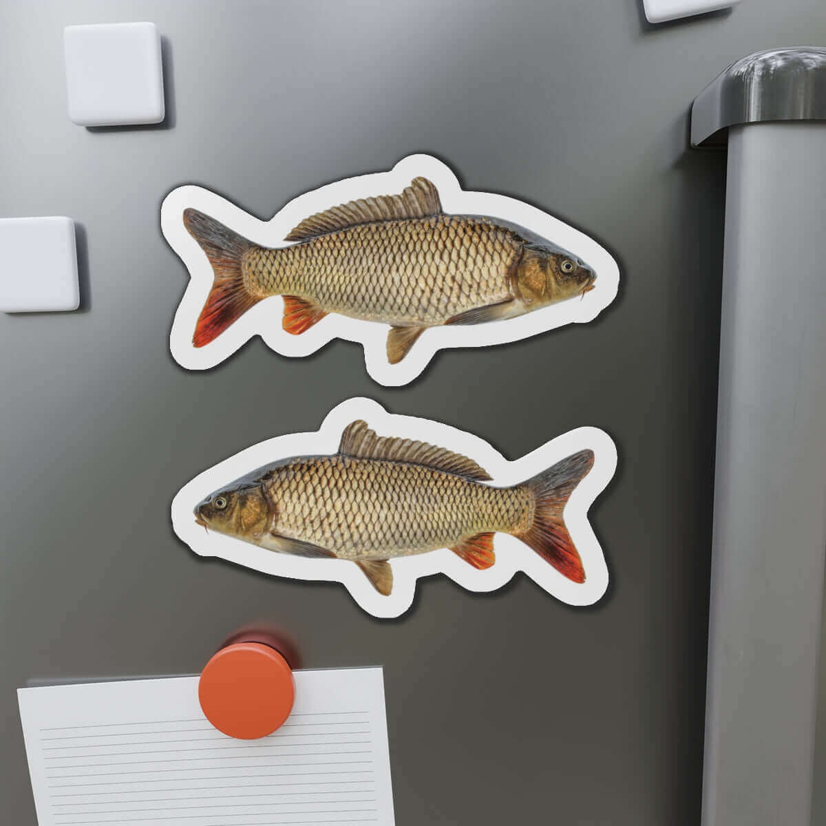 Carp-shaped fish magnets on fridge door adding a natural flair.