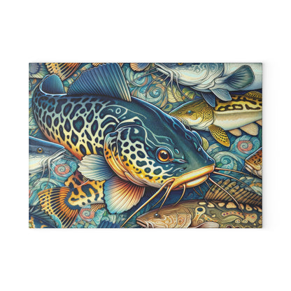 Vibrant catfish design on a glass cutting board with other colorful fish in the background.