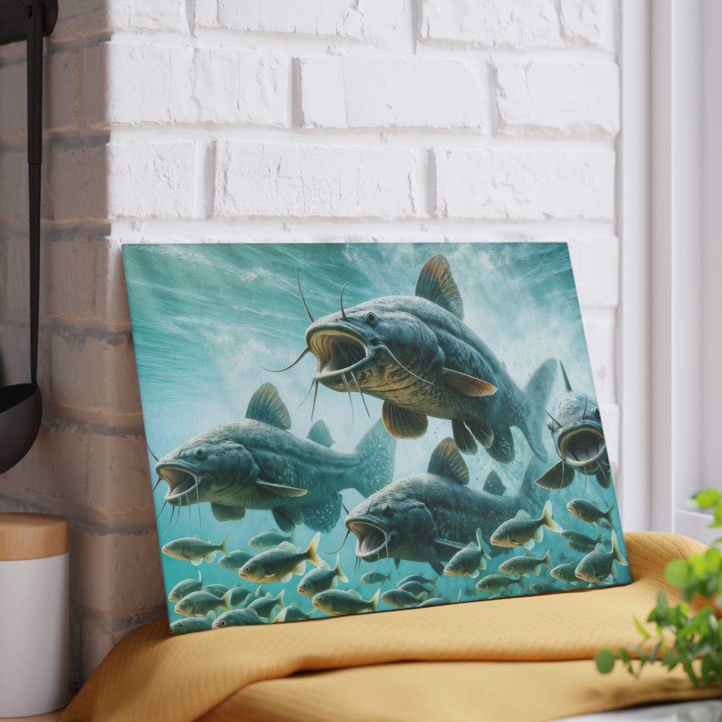 Catfish Glass Cutting Board with vibrant fish design displayed on a kitchen counter against a brick wall