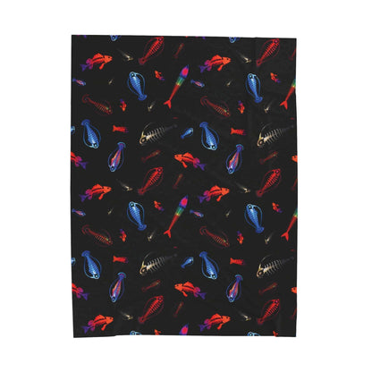 Glowing skeleton fish plush blanket with vibrant underwater fish pattern on a black background.