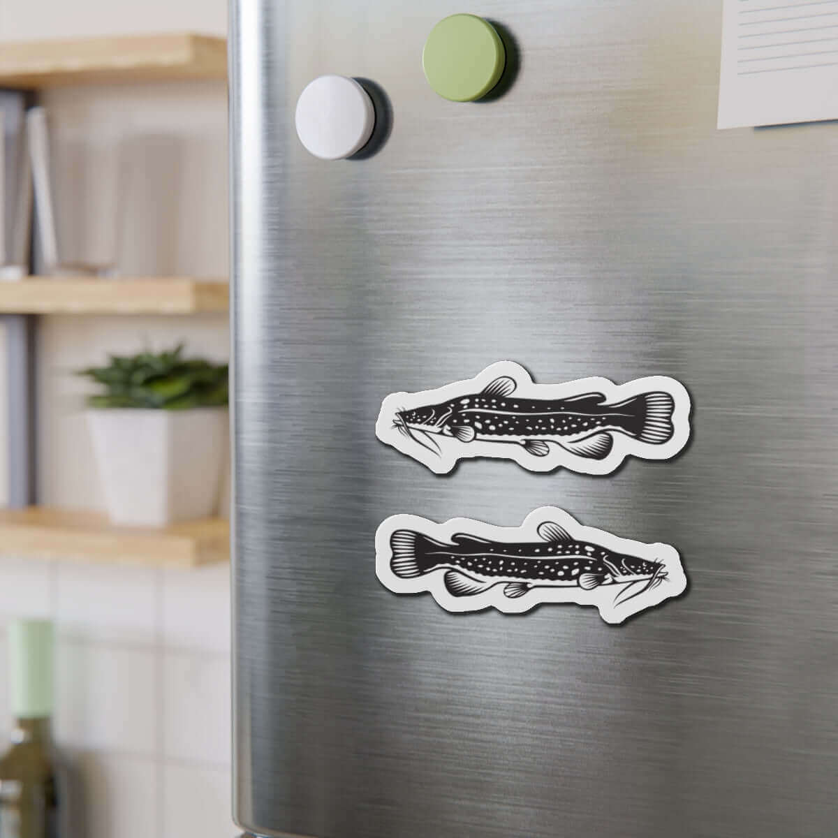 Flathead Catfish fish-shaped magnets on stainless steel fridge, perfect for fish décor and fun kitchen accents.