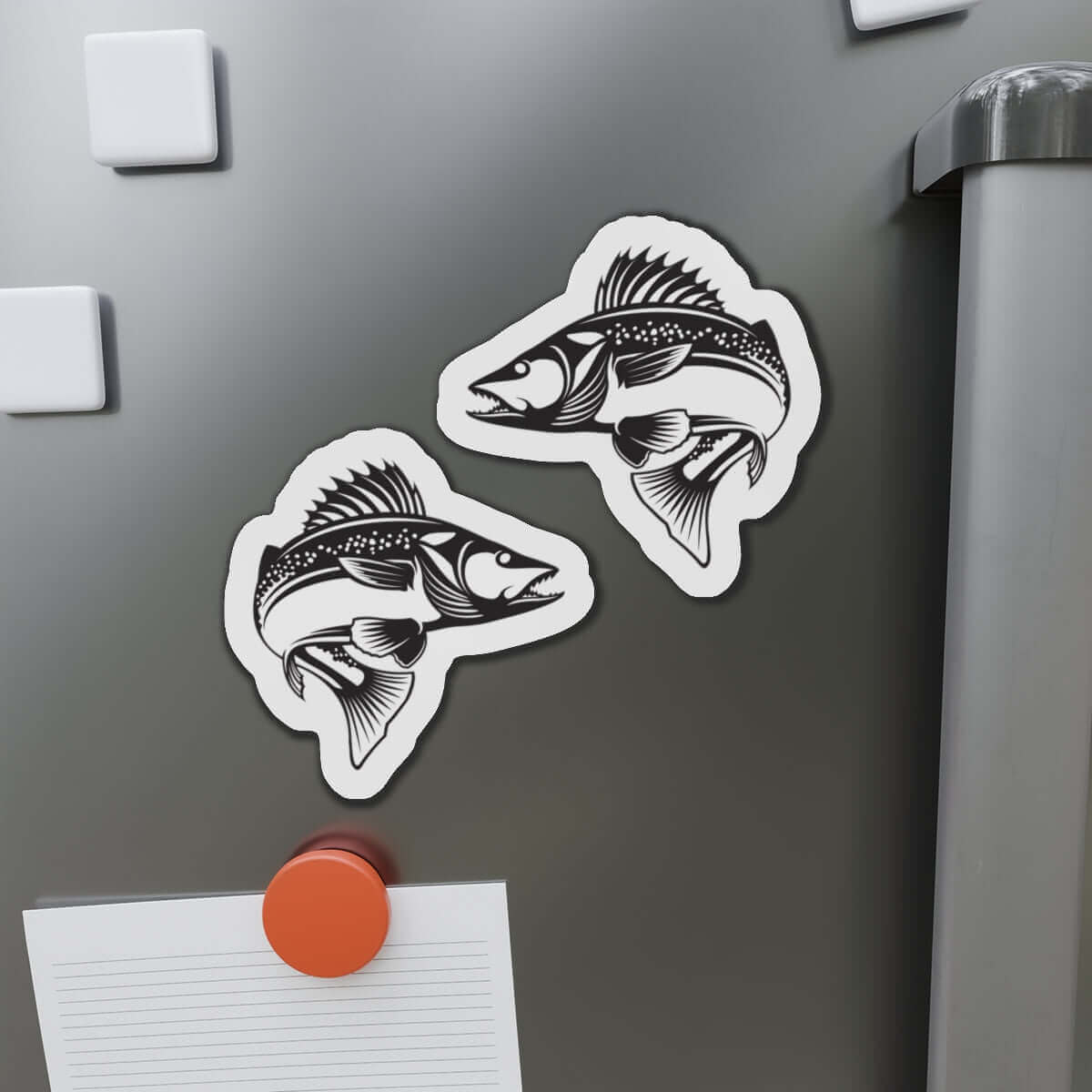 Walleye fish shaped magnets on a fridge, featuring left and right-facing designs for fun kitchen décor.