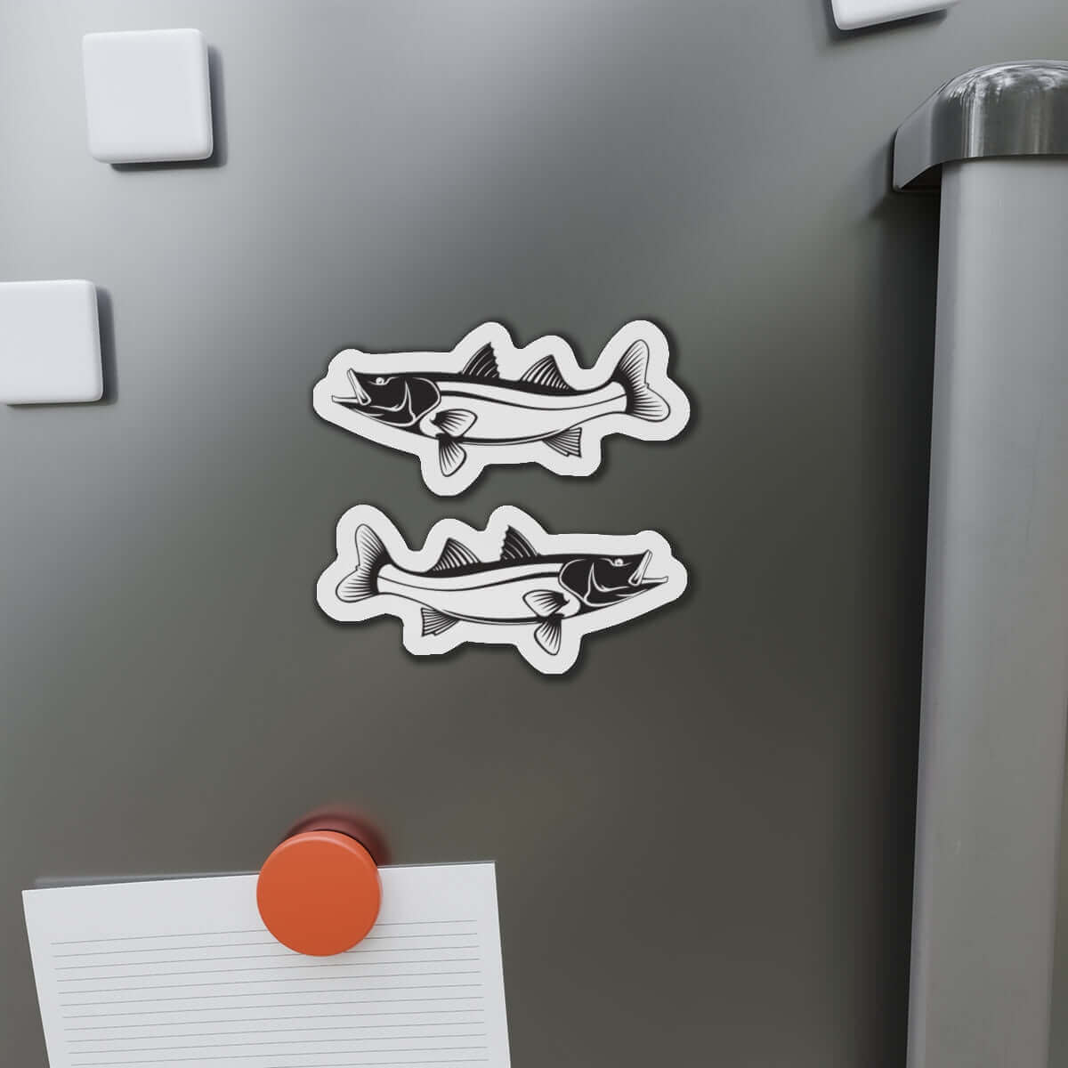 Snook fish-shaped magnets on fridge, adding fun fish décor and flair to kitchen surfaces