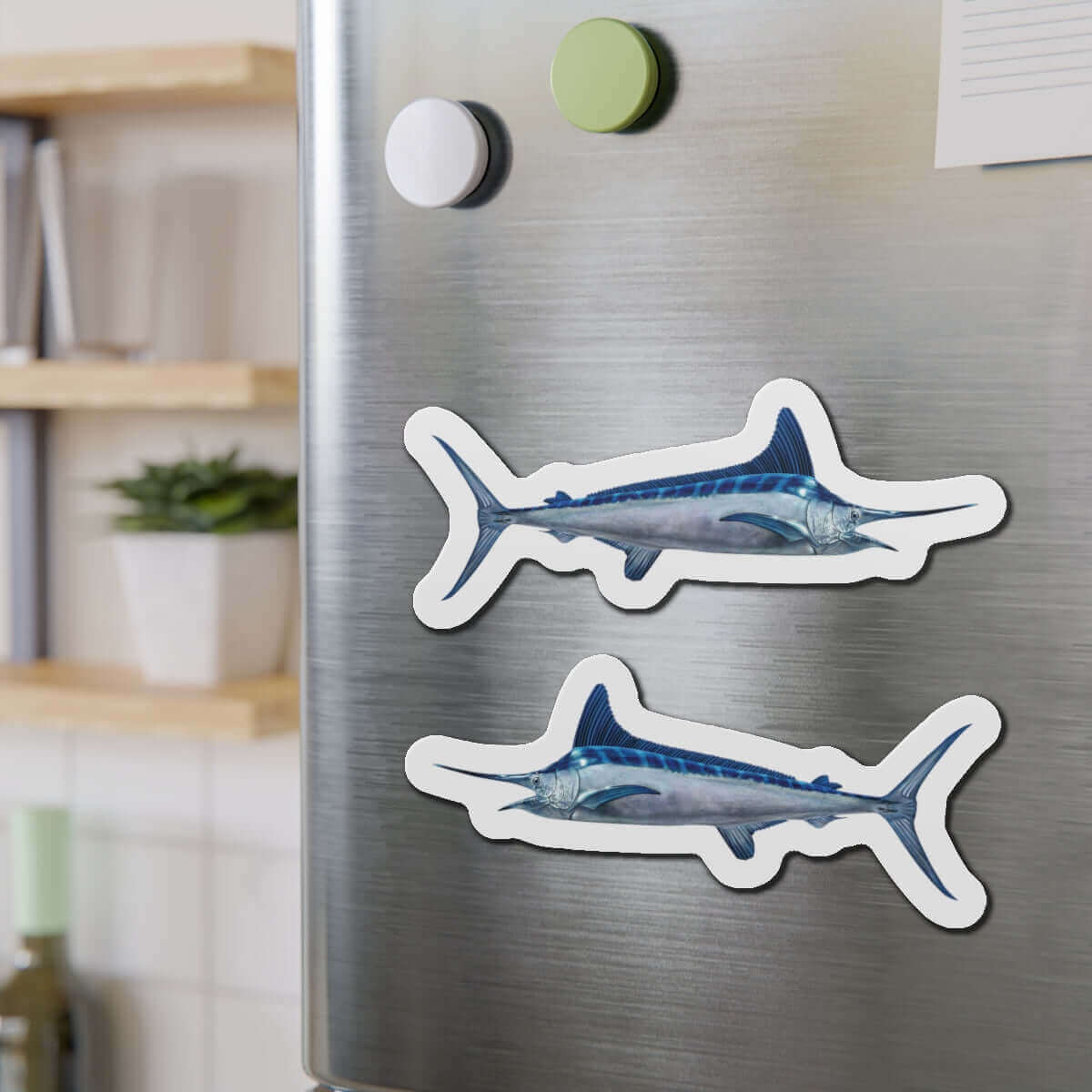 White Marlin fish shaped magnets on stainless steel fridge, ideal for fishing fans and fun kitchen décor.