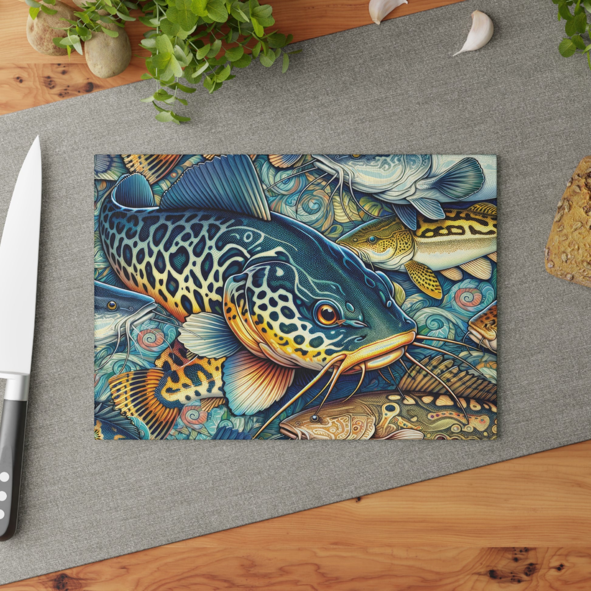 Vibrant Catfish Glass Cutting Board on kitchen counter with knife, featuring detailed fish design, perfect for food prep and kitchen decor