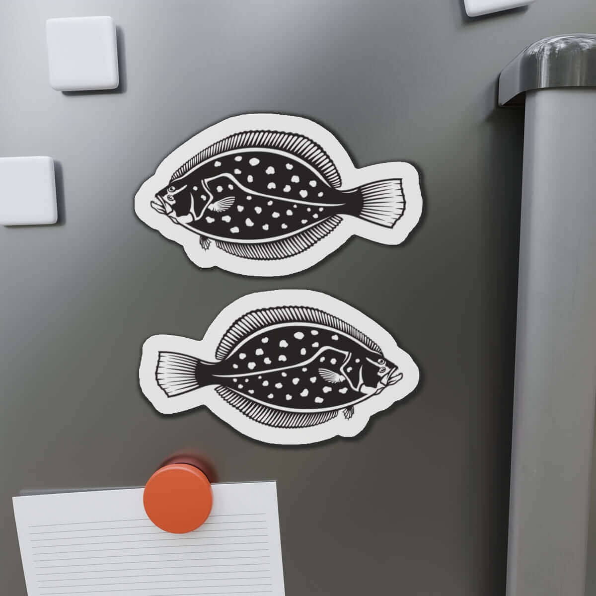 Winter Flounder fish shaped magnets on fridge, adding fun kitchen décor for fishing fans.