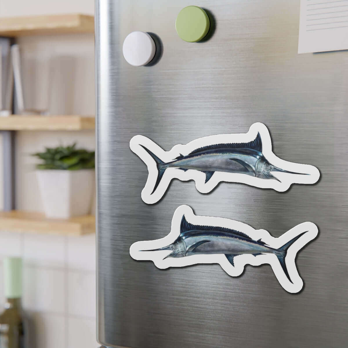 Black Marlin fish-shaped magnets on a fridge adding a fun kitchen flair.