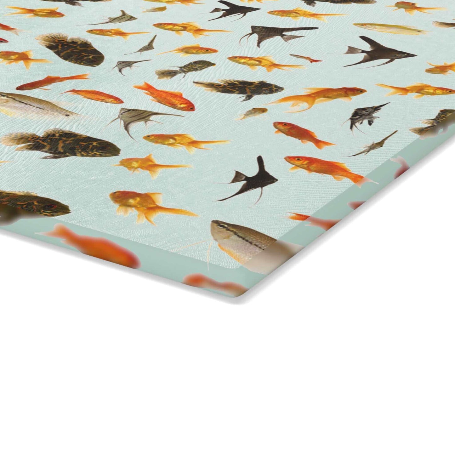 Vibrant fish design on durable tempered glass cutting board for kitchen decor.