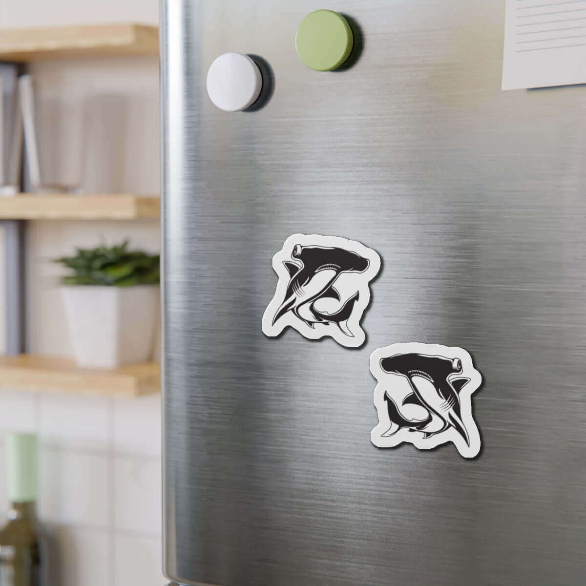 Hammerhead Shark fish magnets on refrigerator, adding fun fish décor to kitchen.