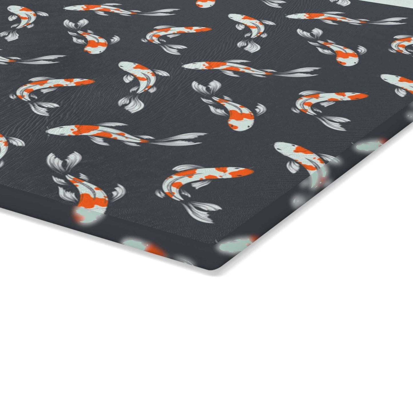 Colorful carp and koi fish on black glass cutting board with vibrant fish design.