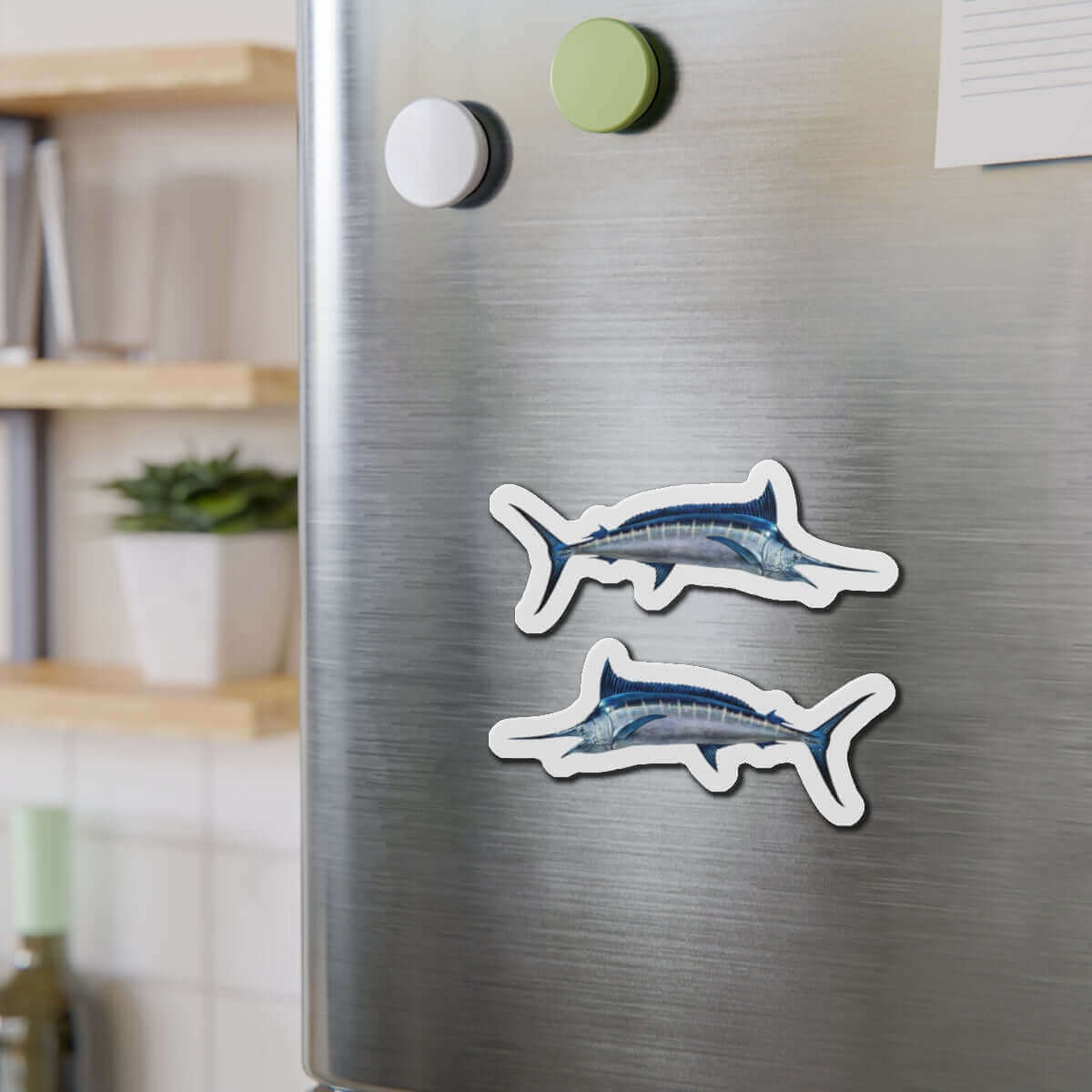 Blue Marlin fish shaped magnets on a fridge, perfect for fish décor and fishing enthusiasts.