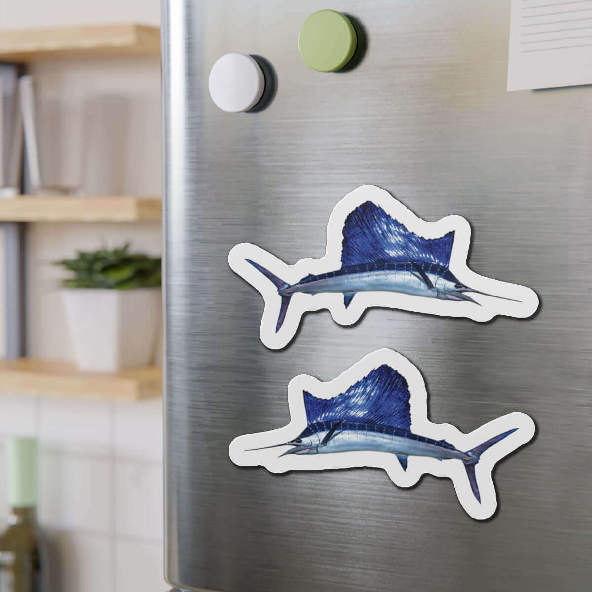 Sailfish-shaped magnets on a fridge, perfect for fish décor and fishing fridge magnets enthusiasts.