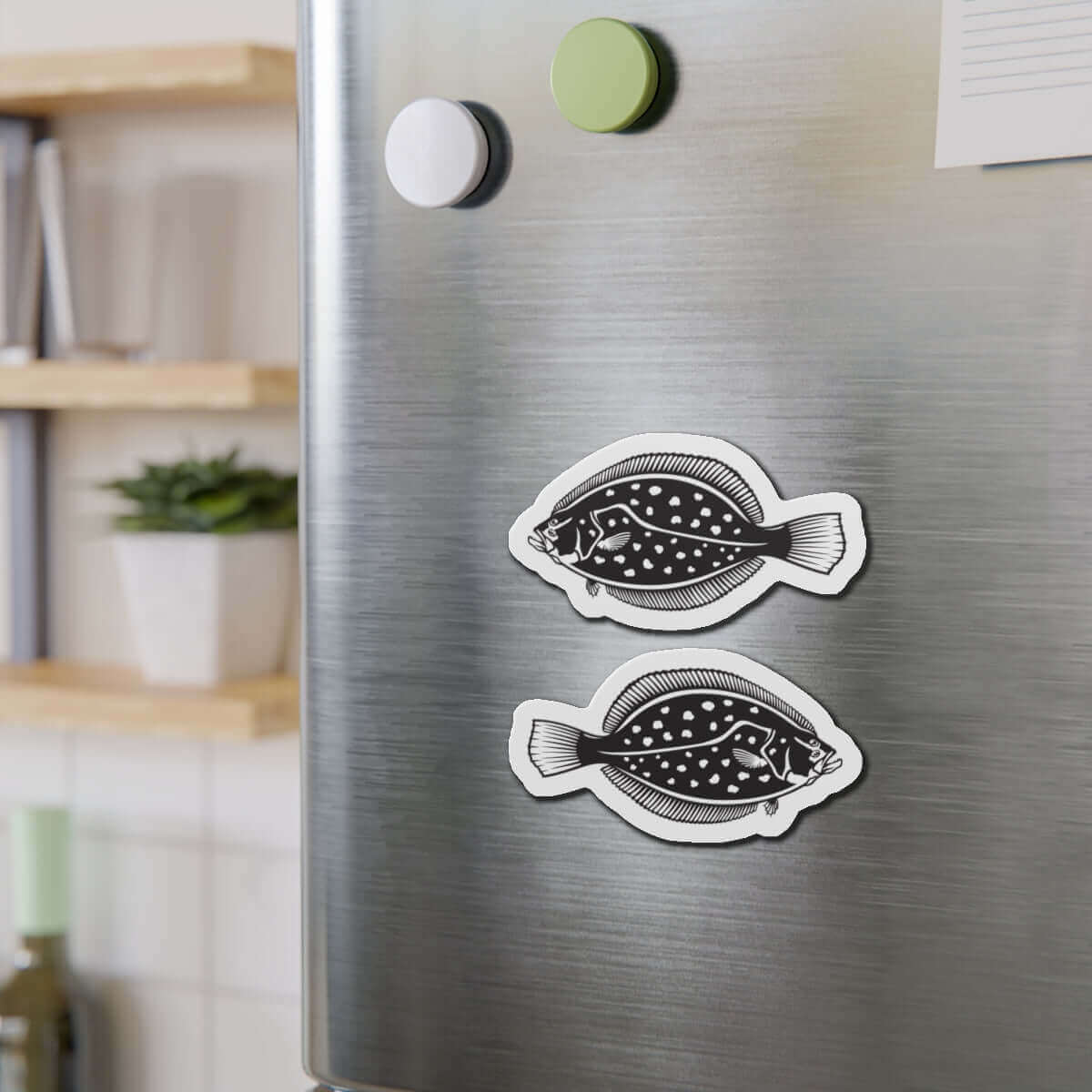 Winter Flounder fish shaped magnets on a fridge door, adding fun fish décor to the kitchen.