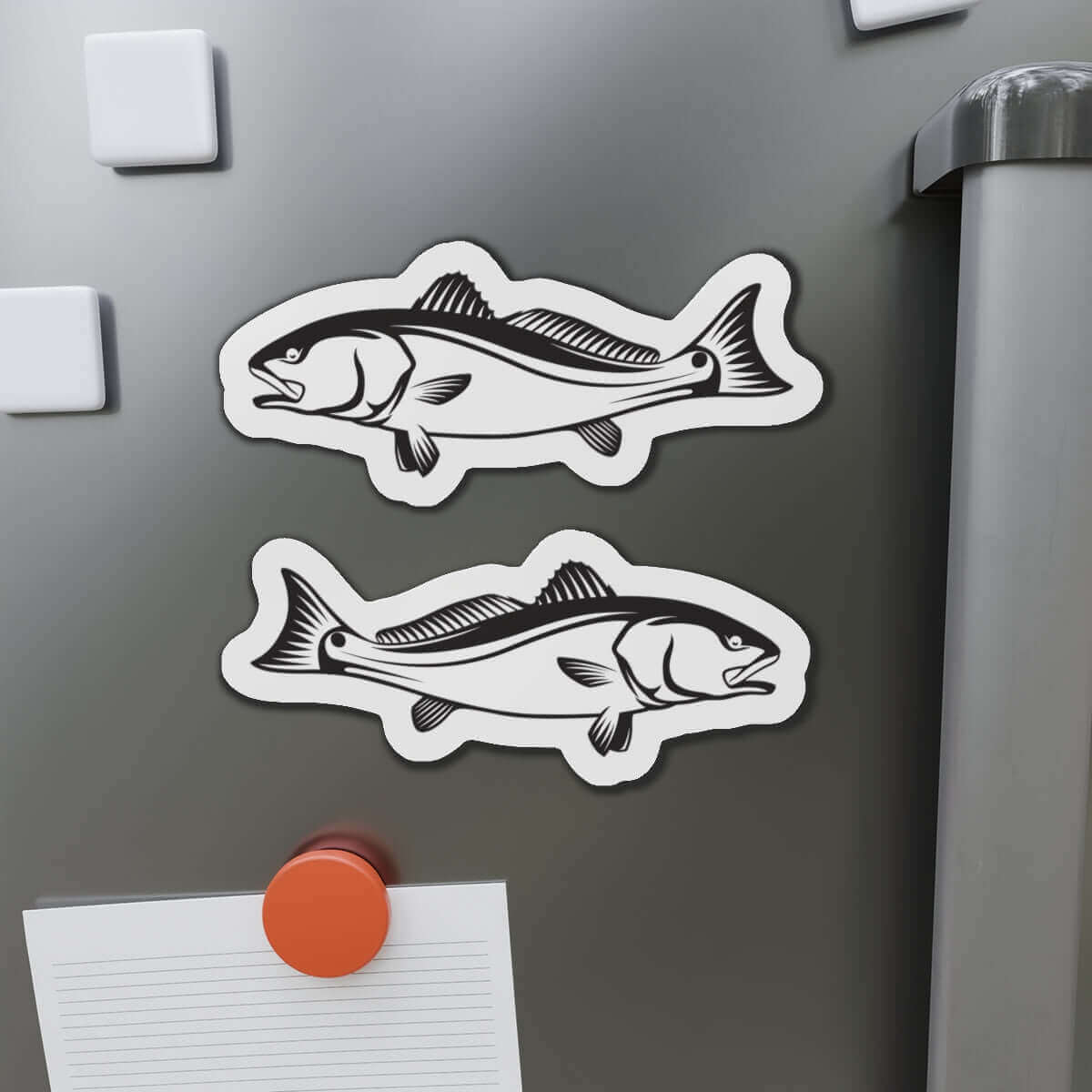 Red Drum fish shaped magnets on a fridge door, showcasing fun kitchen décor for fishing fans.