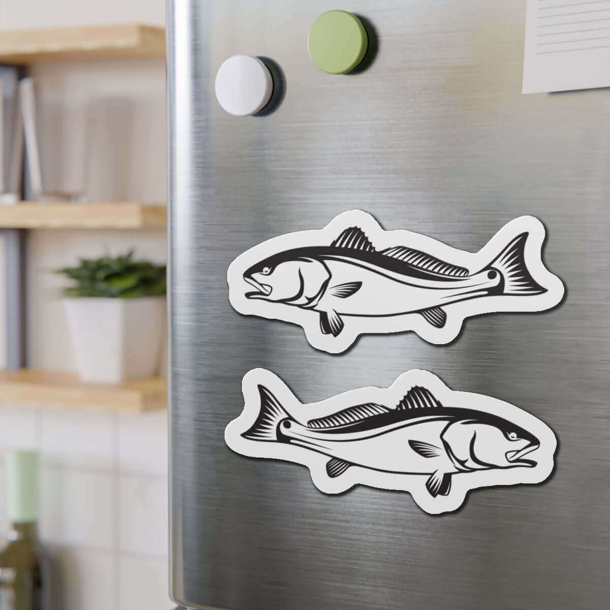 Red Drum fish shaped magnets on stainless steel fridge, perfect for fish décor or fun kitchen magnets.