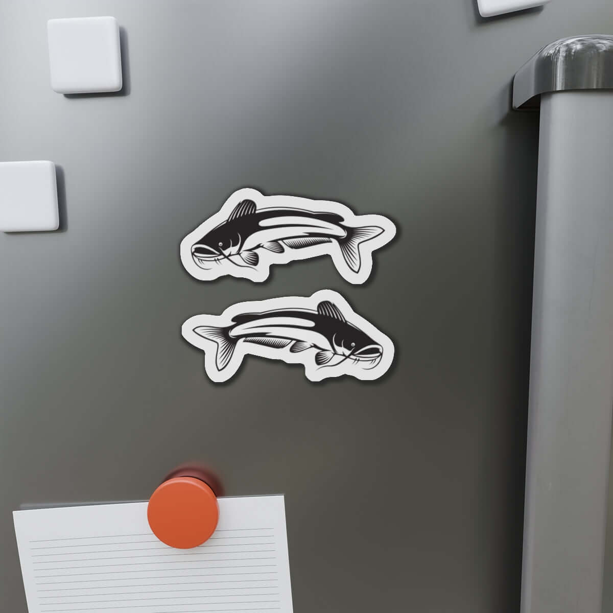 Catfish-shaped magnets adding a natural flair to a metallic surface with fishing-themed design. Perfect for fishing enthusiasts.