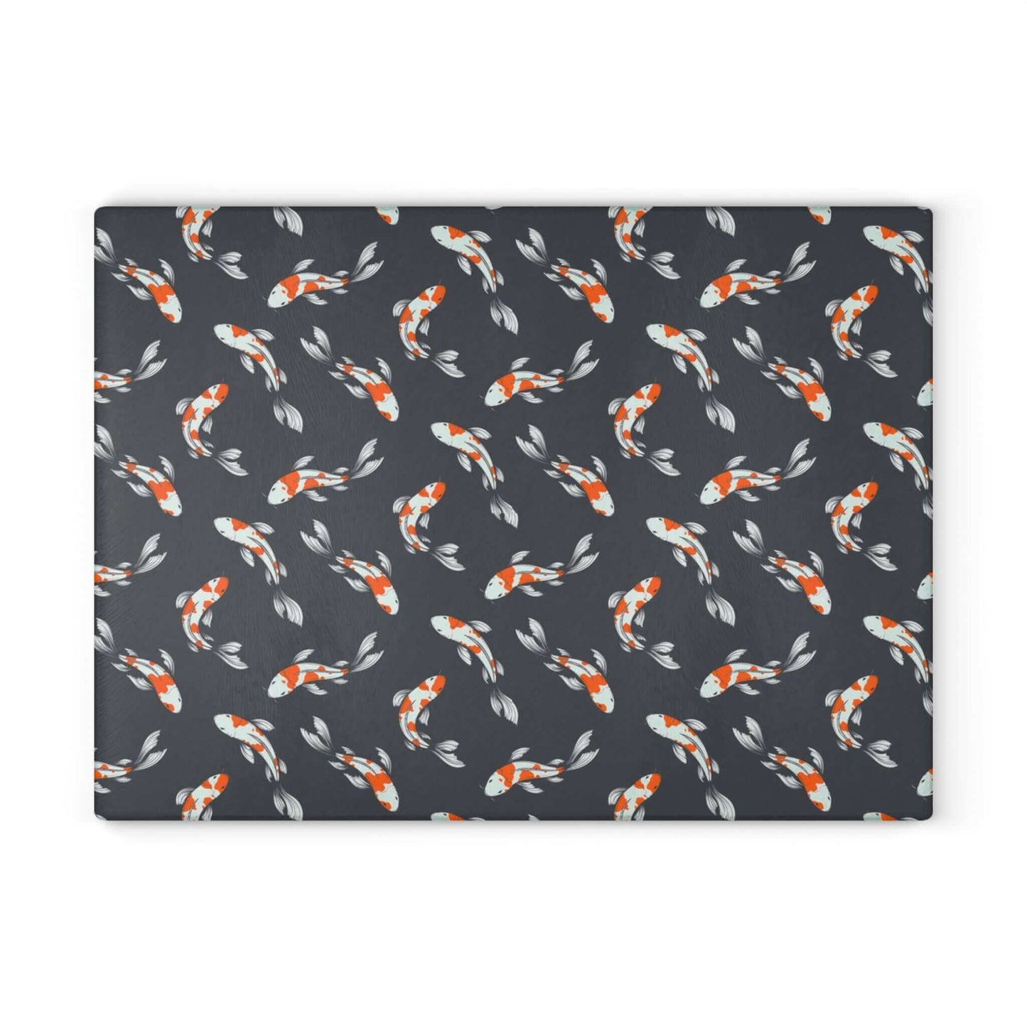 Carp and koi fish design glass cutting board with vibrant orange and white fish on a dark background.