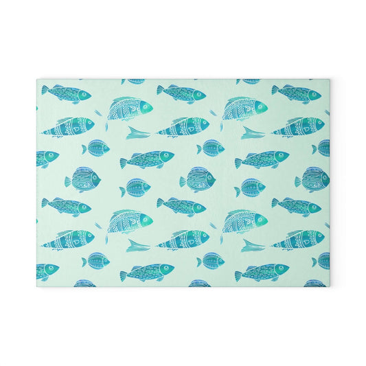 Vibrant blue and green fish decor glass cutting board with playful fish pattern, perfect for stylish kitchen display or food prep.