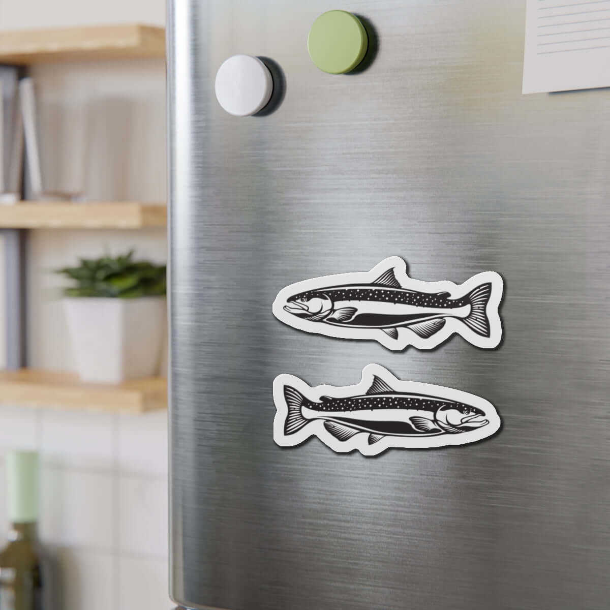 Chinook Salmon fish shaped magnets on refrigerator, adding natural flair to kitchen décor.