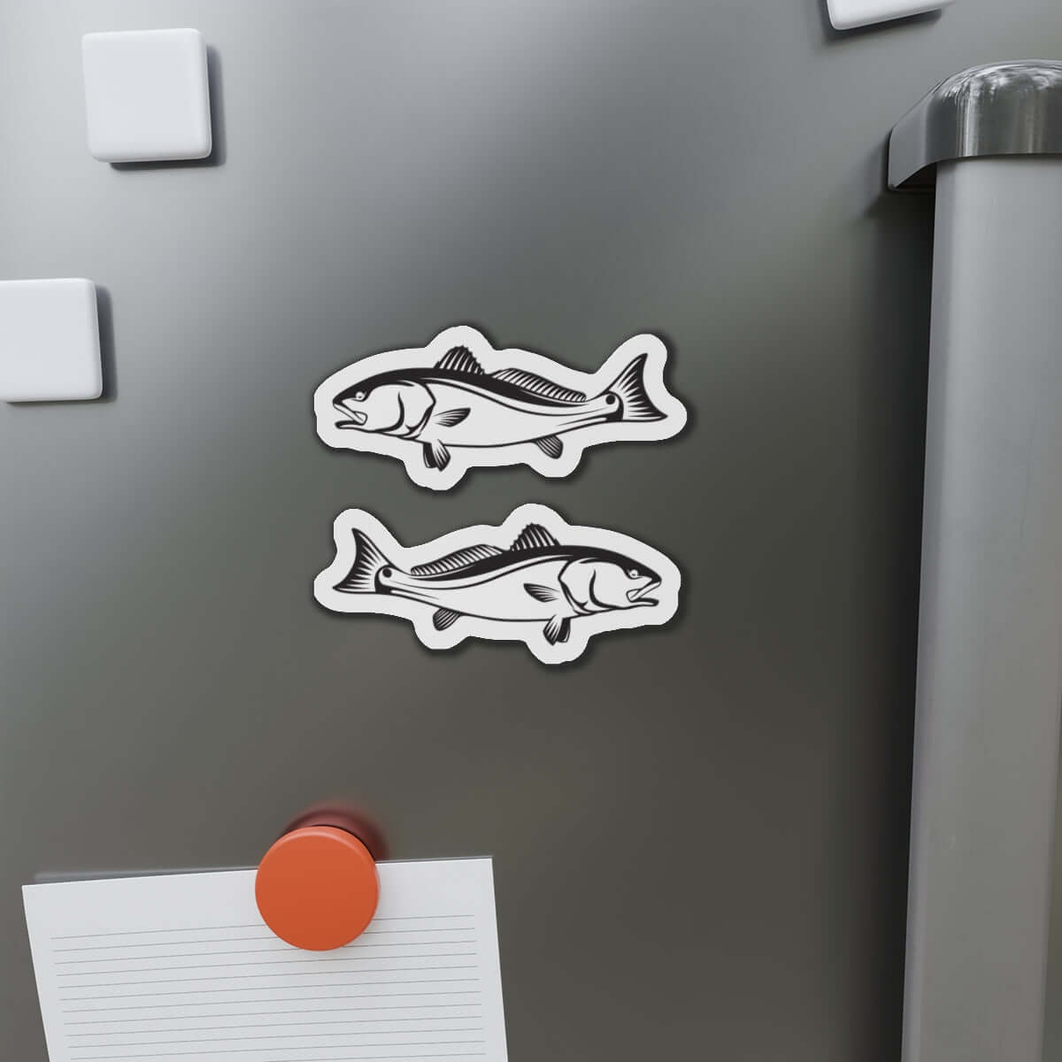 Red Drum fish shaped magnets on fridge, fun kitchen décor for fishing enthusiasts.