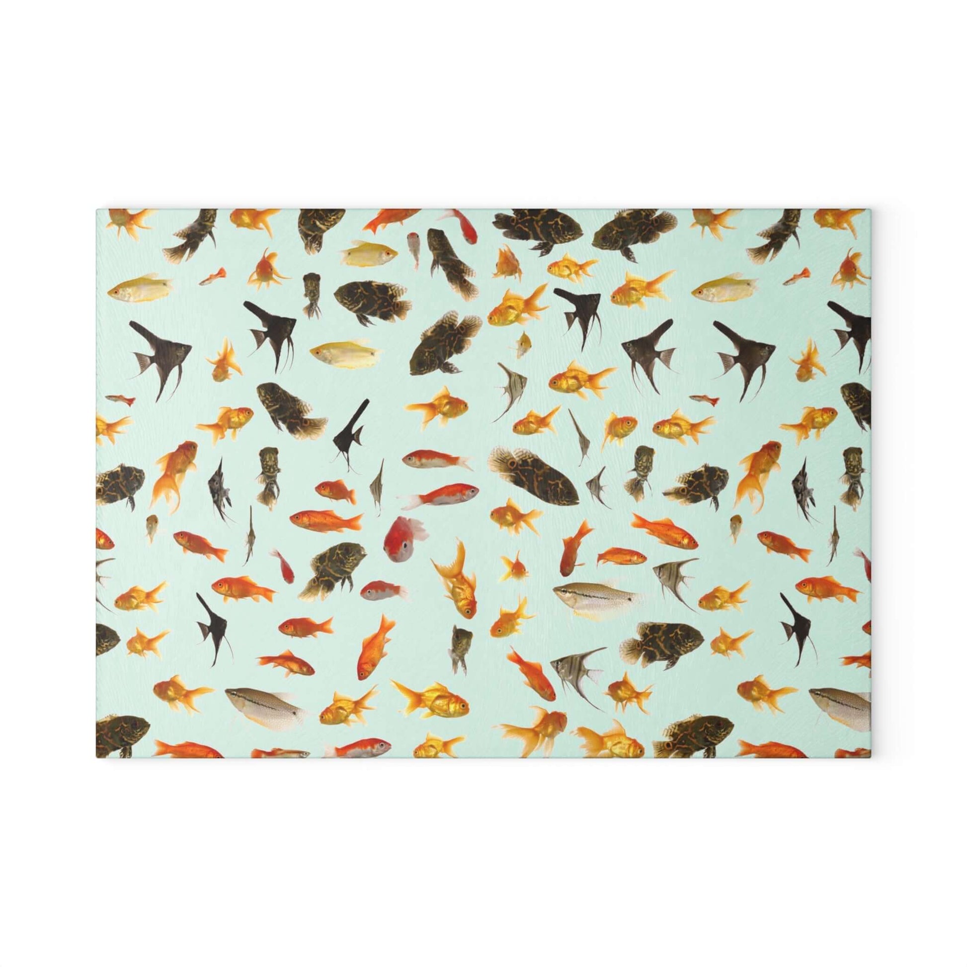 Colorful aquarium fish design on a tempered glass cutting board for kitchen decor and food prep.