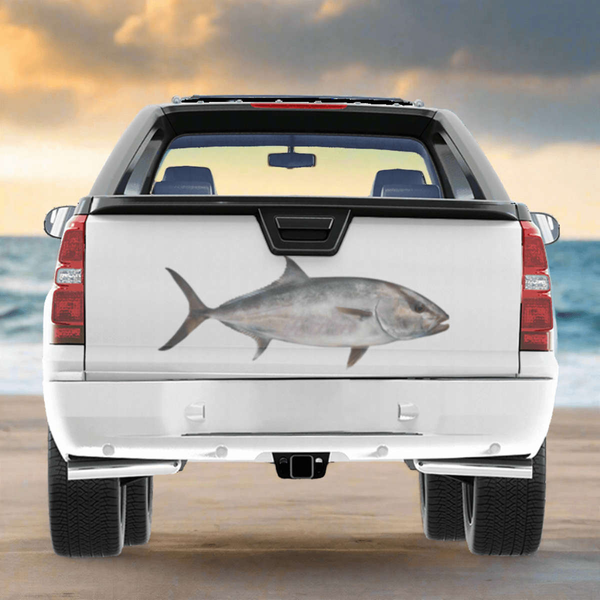 A large Amberjack decal on a truck, driving on a beach.