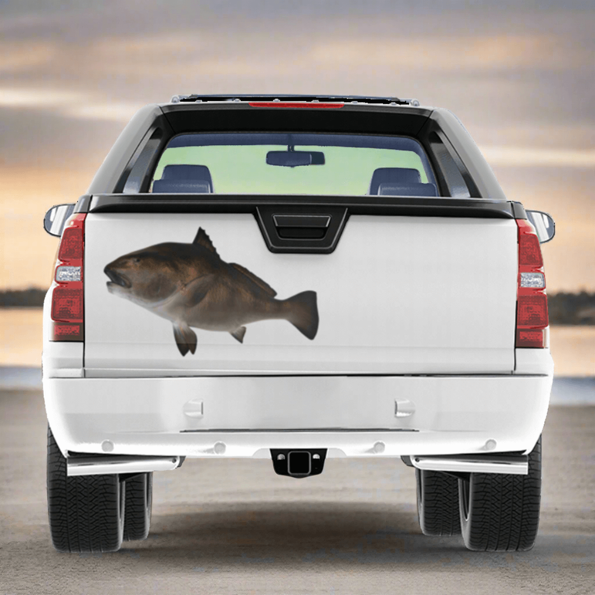 Large Black Drum decal on a truck near a fishing boat harbor.