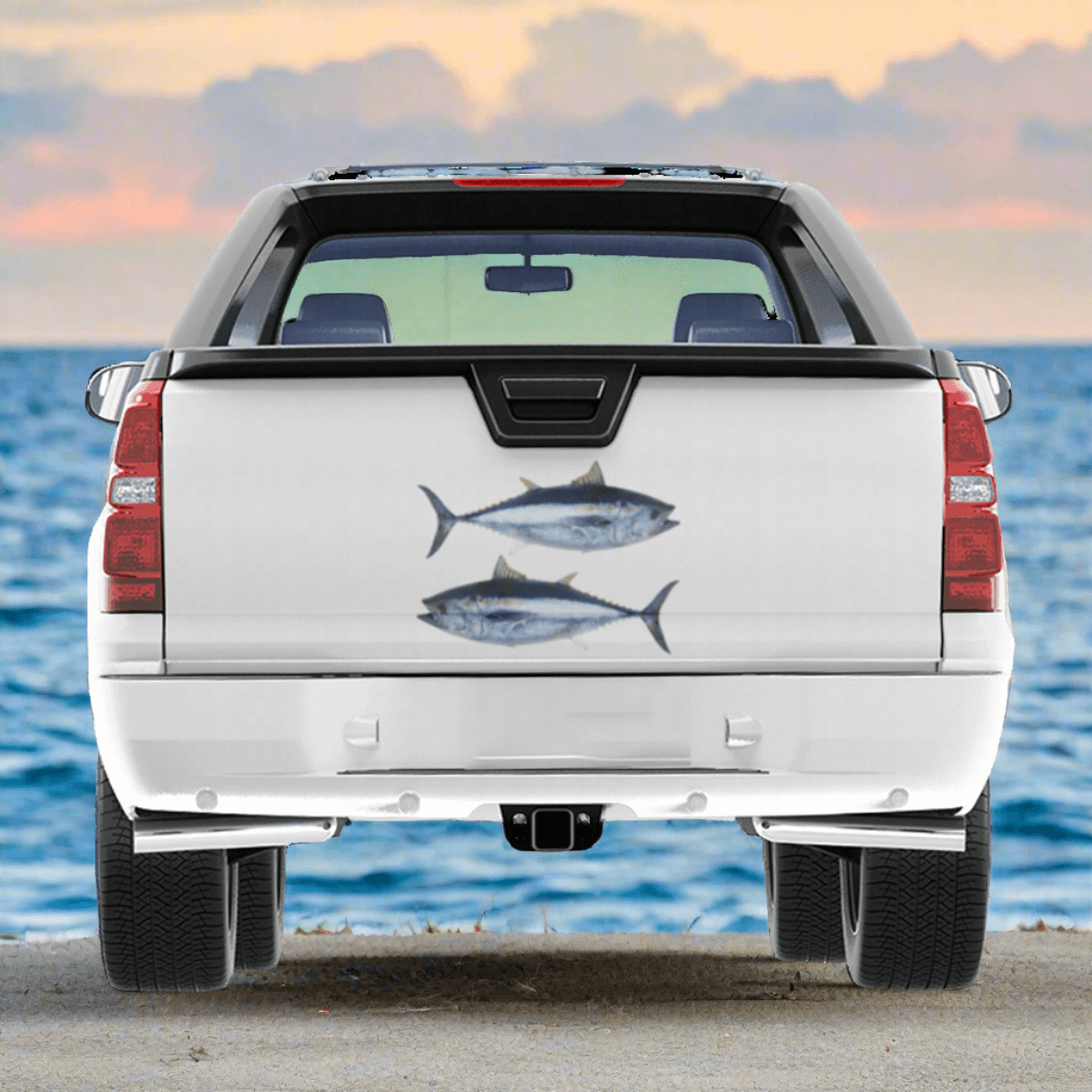 Large Bluefin Tuna decals on a truck near the ocean.