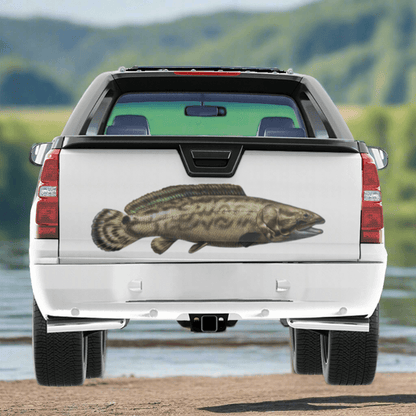 Large Bowfin decal on a pickup truck near a river.