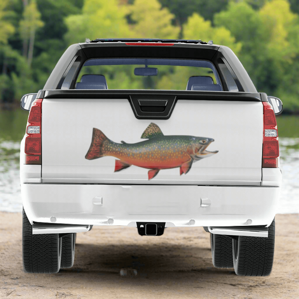 Large Brook Trout decals on a pickup truck near a river.