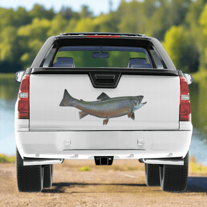 Large Brook Trout decals on a pickup truck near a river.