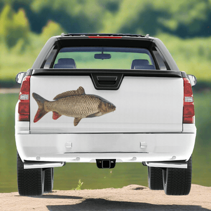 A large Carp decal on a pickup truck near a river.