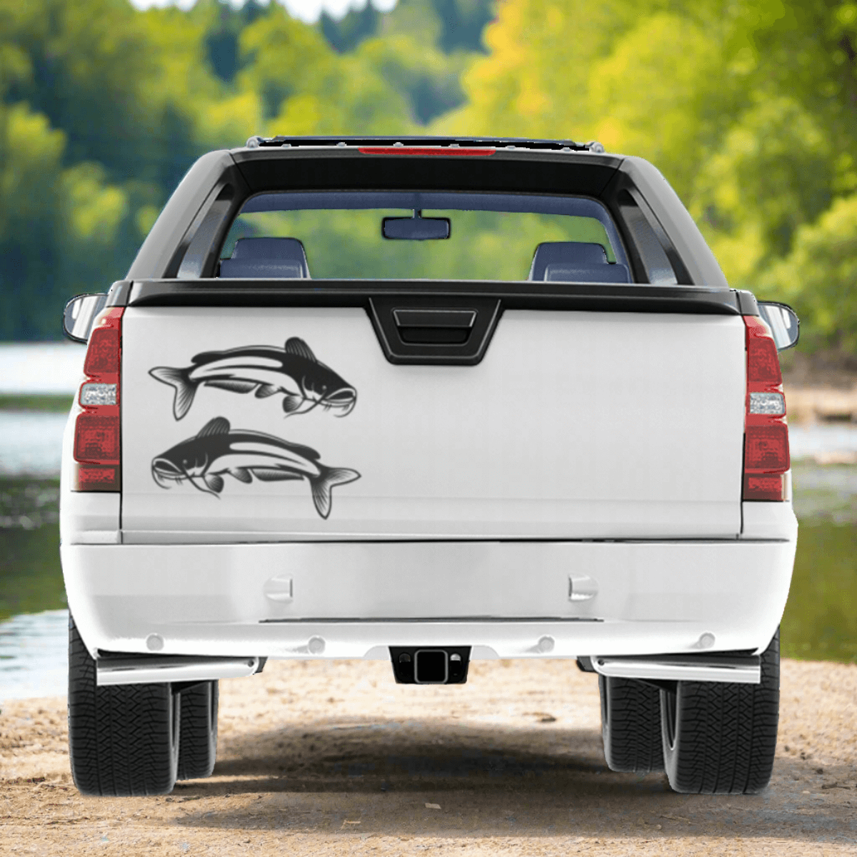 Large Catfish decals on a pickup truck near a river.