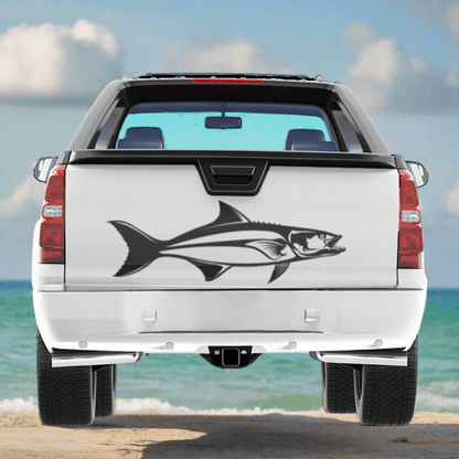 A large Cobia decal on a white pickup truck near the ocean.