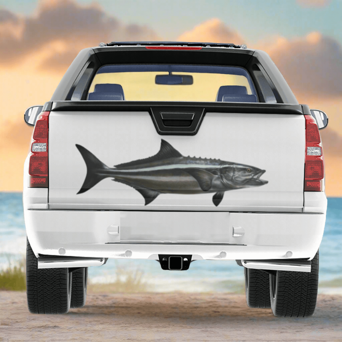 A large Cobia decal on a pickup truck near the ocean.