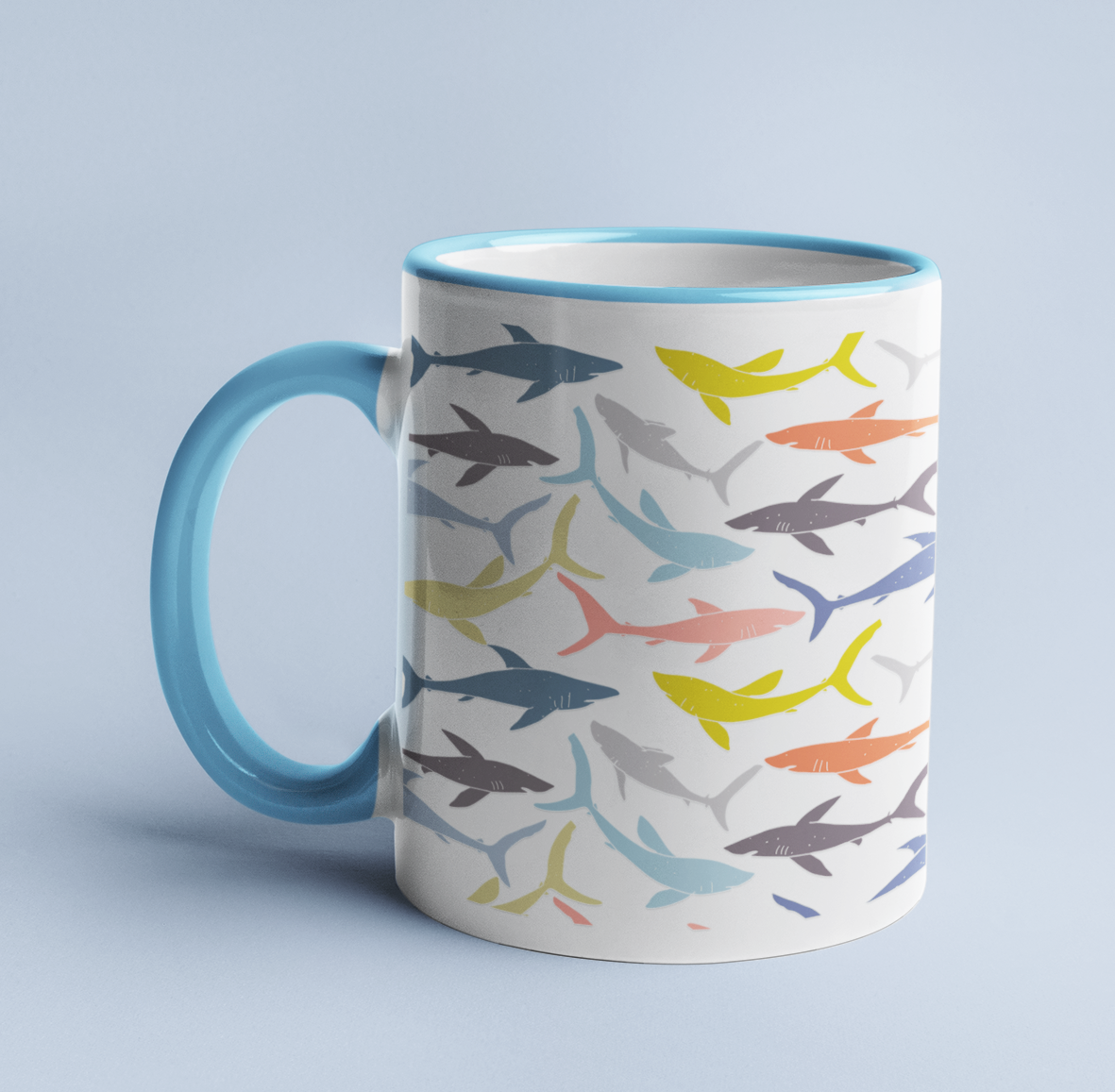 Colorful Reef Sharks Pattern mug on a light blue background, with a light blue handle and rim.