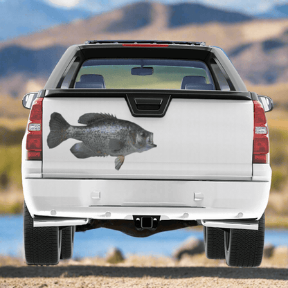 Large Crappie decals on a pickup truck near a freshwater river.