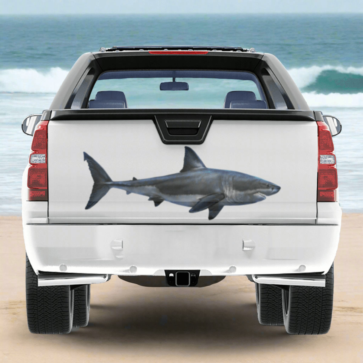 Large Great White Shark decal on a pickup truck by the ocean.