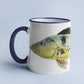 Peacock Bass accent mug with dark blue handle on light blue background.