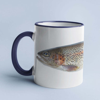 Coffee mug with a trout fish design and navy blue handle against a light blue background.