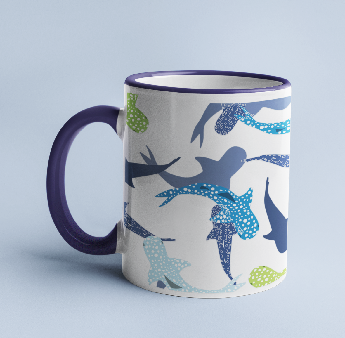 Reef Sharks Design mug on a light blue background, with a dark blue handle and rim.