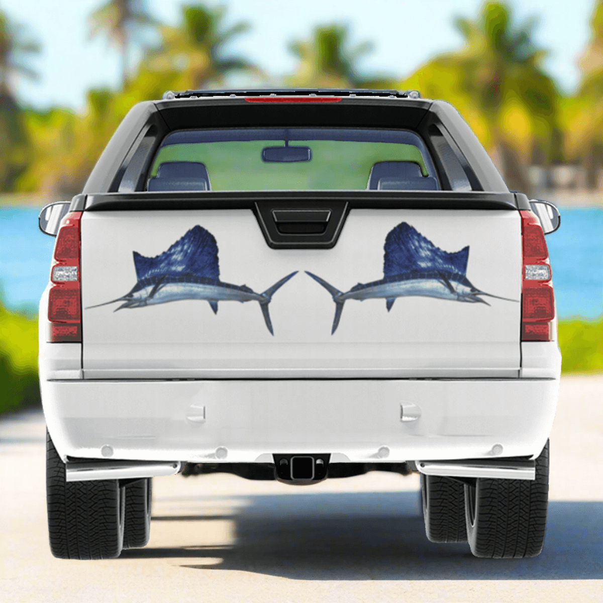 Sailfish large decals on a pickup truck parked by the ocean.