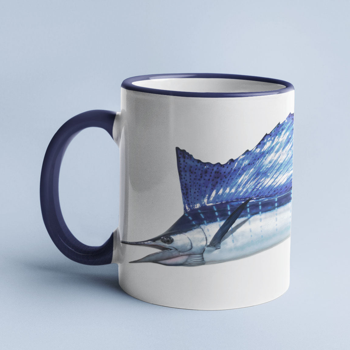 Sailfish accent mug with dark blue handle on light blue background.