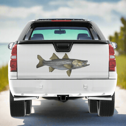 Large Snook decal on a pickup truck by a saltwater estuary system.