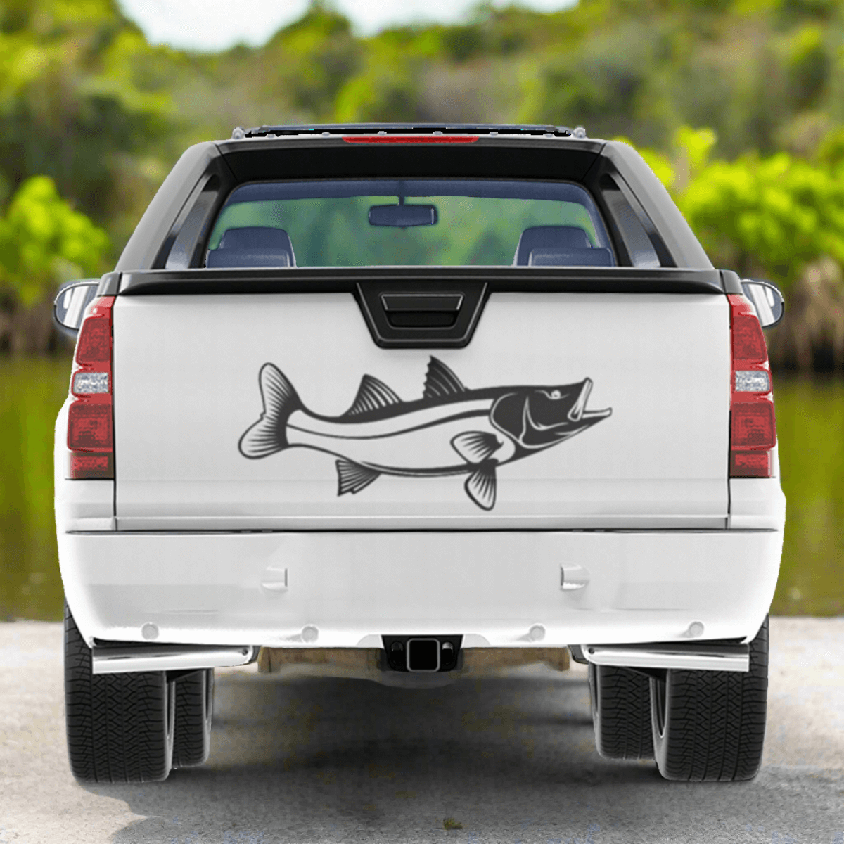 Snook large decal on a pickup truck parked by a saltwater estuary.