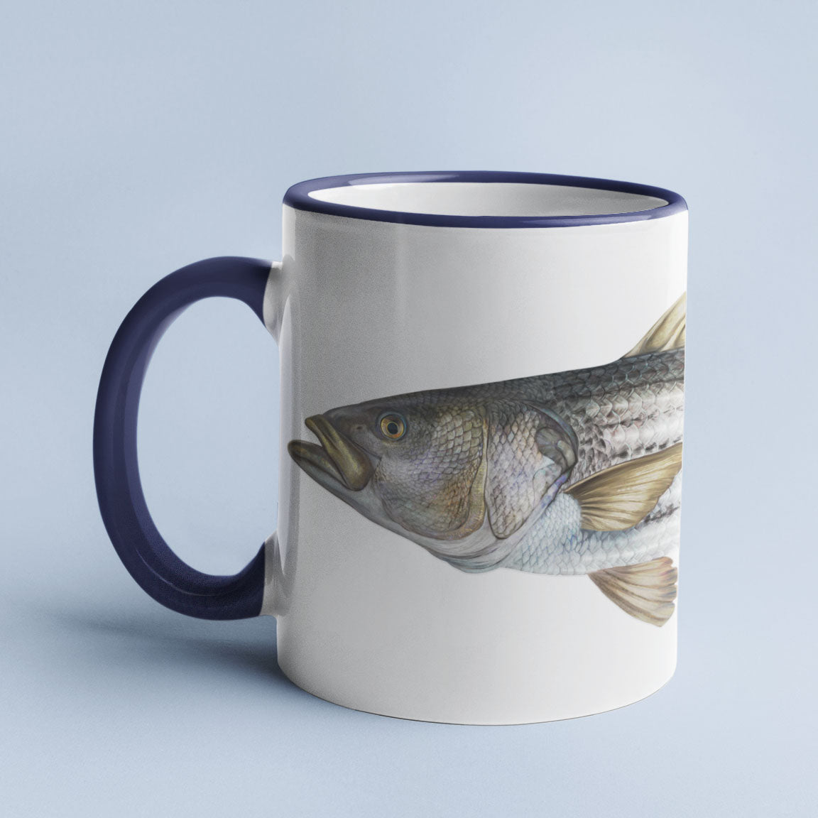 Striped Bass accent mug with dark blue handle on light blue background.