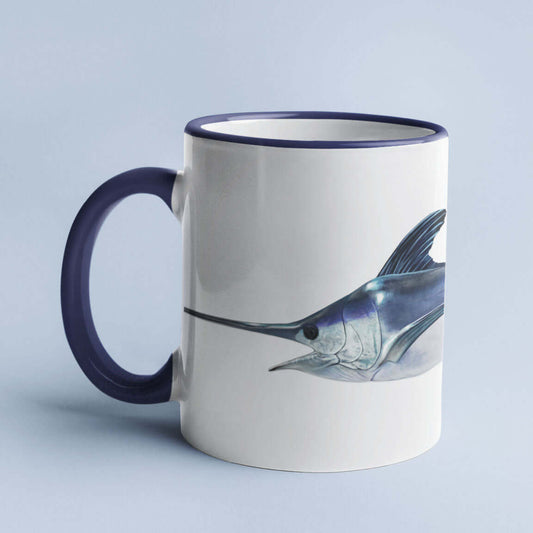 Ceramic mug with a blue marlin fish illustration, featuring navy blue handle and rim, placed against a light background.