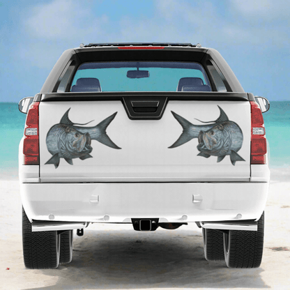 Tarpon large decals on a pickup truck near the ocean.